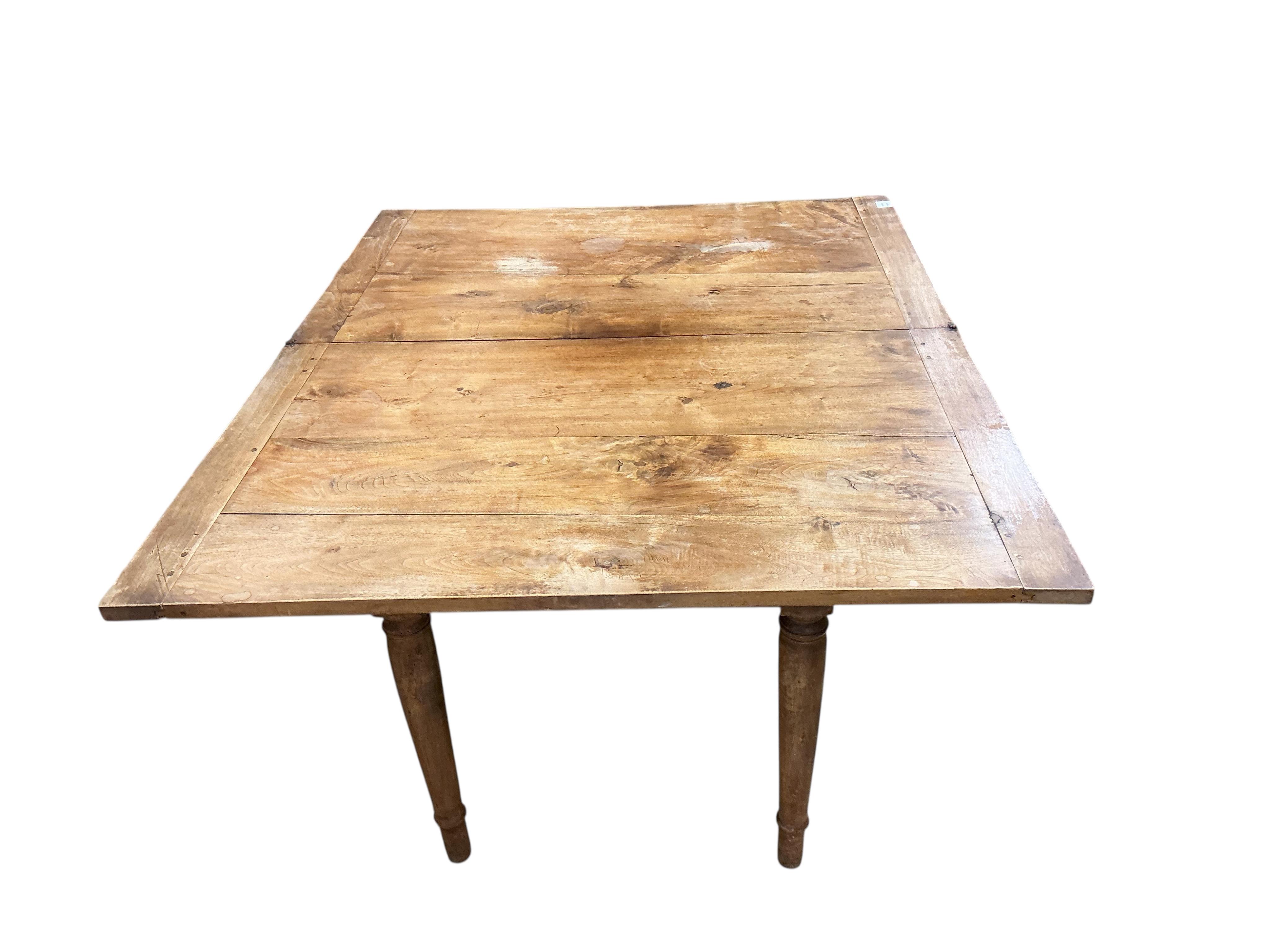 A 19th century French folding fruitwood kitchen table, width 117cm, depth 72cm, height 74cm